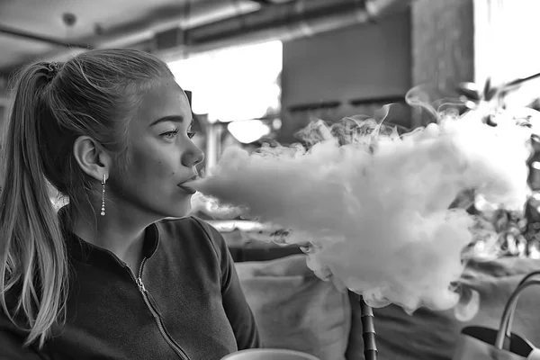girl smokes a hookah at the bar / smoking, health, modern cigarettes vape