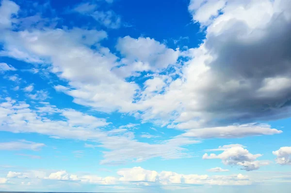 white clouds on blue sky background, abstract seasonal wallpaper, sunny day atmosphere