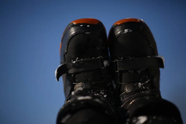 A snow boot close up. Shot of a snow on white snow background.