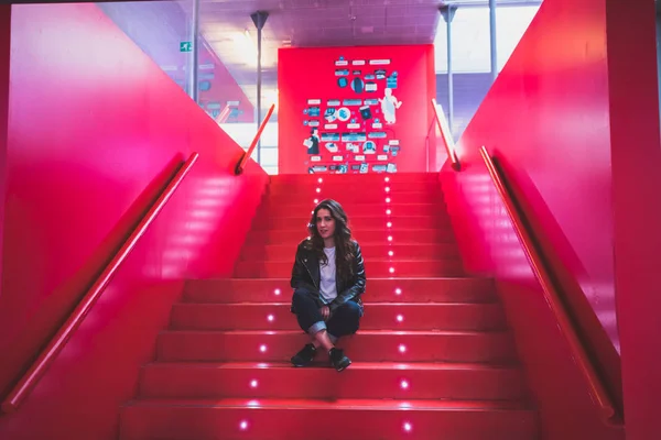 beautiful girl on red stairs with lights
