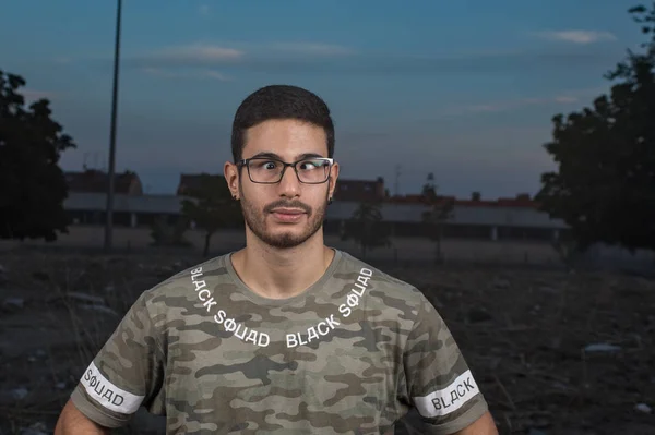 portrait of young cross-eyed man with glasses