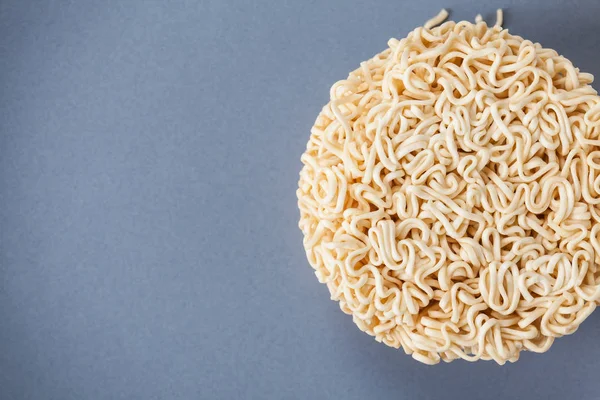 Close up Raw Instant noodles isolated on a gray plate