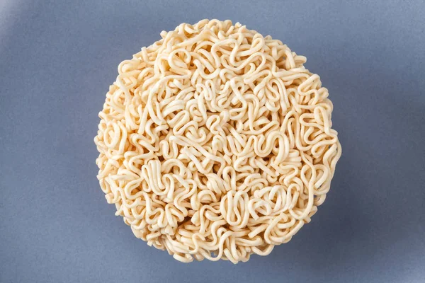 Close up Raw Instant noodles isolated on a gray plate with space
