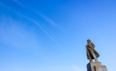 Krasnoyarsk, Rusya - 27 Haziran 2018: bir anıt Vladimir Lenin Krasnoyarsk içinde parlak mavi gökyüzü uçan bir uçak ile zemin karşı. Anıt 1970 montajı. Anıt heykeltıraş Veniamin Pinchuk yazarı