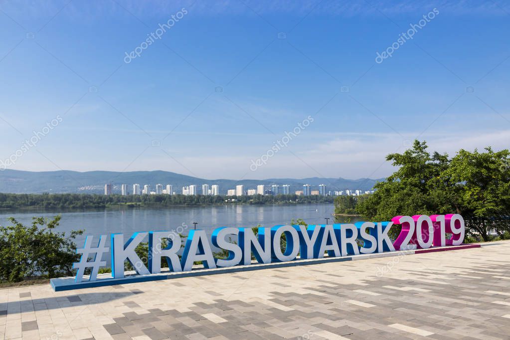 KRASNOYARSK, RUSSIA - June 27, 2018: Cityscape of the embankment of the of the Yenisei river and logo sign XXIX Winter Universiade in summer day