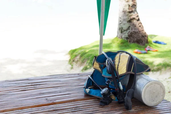 Full set of scuba diving equipment and snorkeling on shore on the wood boards. Background with copy space for active travels, sea vacation and advertising.