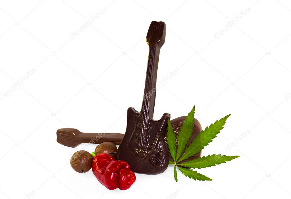 Funny concept background of Sex, drugs, rock and roll. Chilli Willy pepper as sex, chocolate as rock music and cannabis leaf as drug isolated on white background.