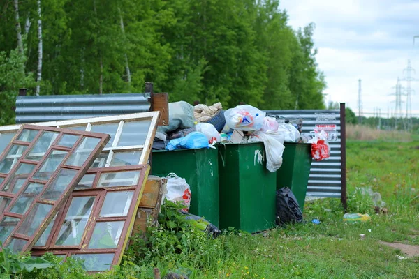 Full garbage containers in meadow — Stock Photo, Image