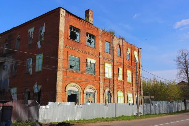 1858 'de kurulan Zaraysky tüy fabrikasının kırık camlarıyla terk edilmiş eski bir tuğla binanın yan görüntüsü..