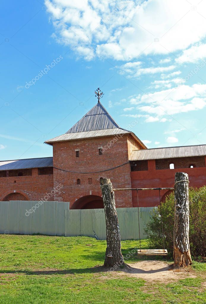 View of the fenced area of restoration work and partially on Savior Gate tower with Kremlin wall in the internal territory of the Zaraysk Kremlin.