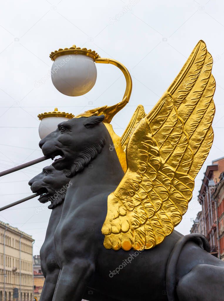 Detail of Griffon sculpture '1826' of the Bank Bridge in Saint Petersburg, Russia. Lion with golden wings and lantern