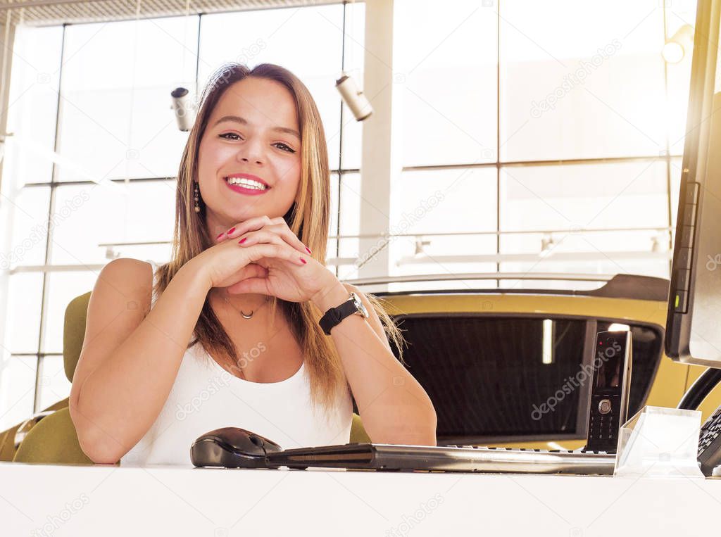 Young woman working at the modern office desk with a laptop, busy with distance learning, tutoring, making online surveys. Lady boss at her workplace. Business success concept. People at work concept