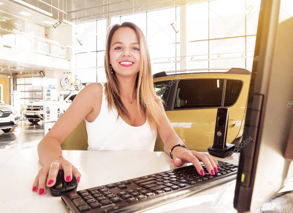 Young woman working at the modern office desk with a laptop, busy with distance learning, tutoring, making online surveys. Lady boss at her workplace. Business success concept. People at work concept