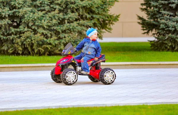 Funny Little Boy Rides Electric Red Car City Park — Stock Photo, Image
