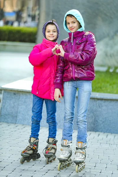 Two Happy Girls Warm Jackets Show Heart Symbol Stone Wall — Stock Photo, Image