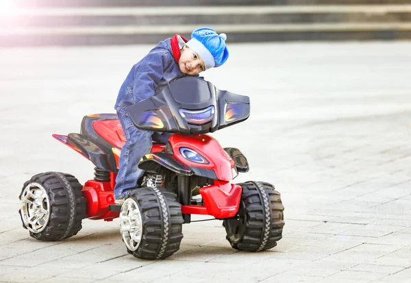 Funny Little Boy Rides Electric Red Car City Park — Stock Photo, Image