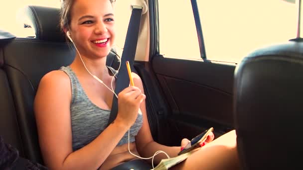 Young Girl Listening Music Using Smartphone While Riding Car Sea — Stock Video