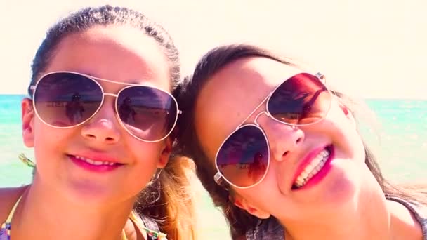Slow Motion Two Young Smiling Girls Faces Blue Sky Background — Stock Video