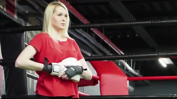 ジムでリングにボクシンググローブを身に着けているブロンドの女性のボクサー — ストック動画