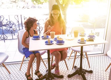 İki Çocuk Kafe'de Dinleniyor. Çocuklar Güzel Genç Erkek ve Kız Kardeş. İnsanlar Bardaklardan Çay İçer.
