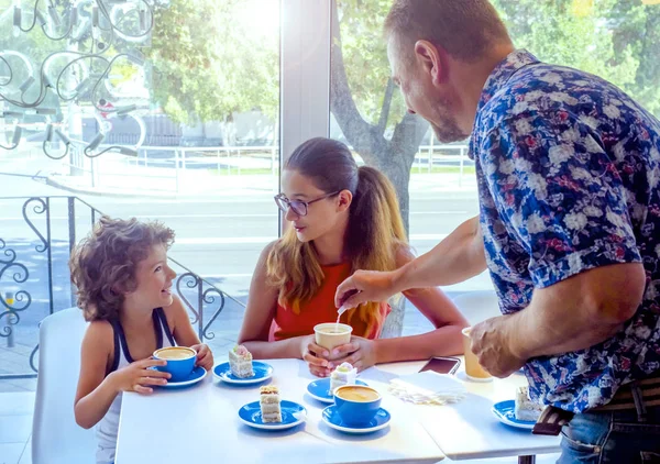 Dining in cafe. family of three enjoying time together in cafe