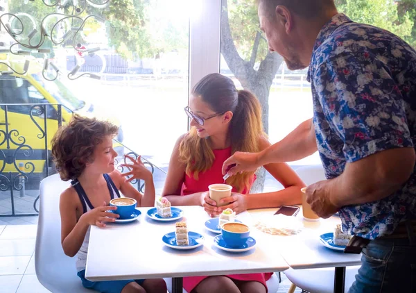 Dining in cafe. family of three enjoying time together in cafe