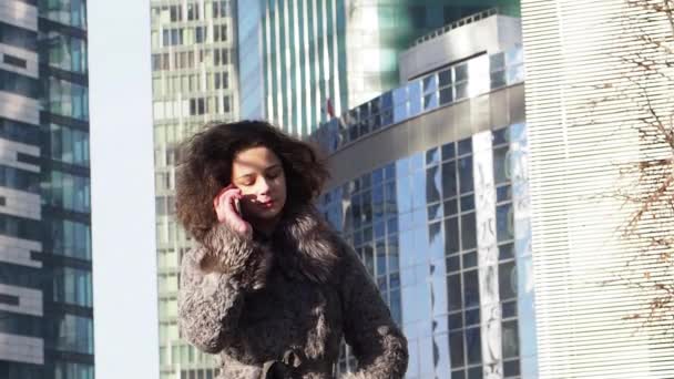 Young Curly Girl Winter Clothes Talking Smartphone Daytime Modern City — Stock Video