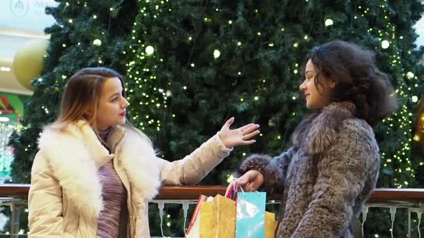 Dwie Dziewczyny Zimowe Ubrania Stojące Centrum Handlowym Torby Zakupy Rękach — Wideo stockowe