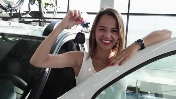 Χαρούμενη Νεαρή Γυναίκα Απολαμβάνει Πρώτο Της Αυτοκίνητο Στην Έκθεση Αυτοκινήτων — Αρχείο Βίντεο