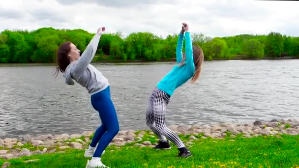 Girls Stretching Outdoor Grass River — Stock Video