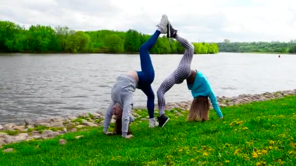 Girls Stretching Outdoor Grass River — Stock Video