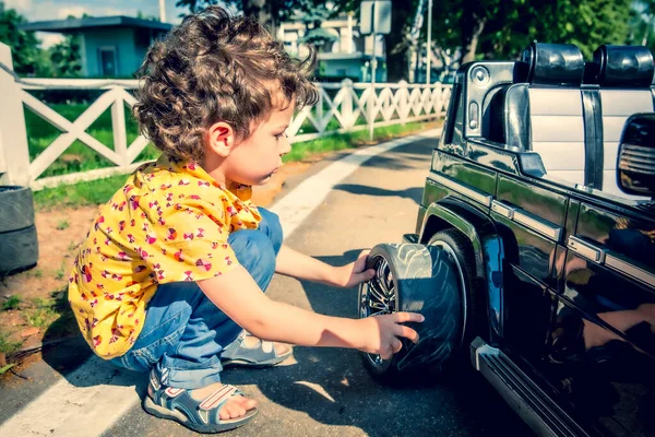 Junge Beim Reifenwechsel Einem Schwarzen Spielzeugauto Kinder Städtischen Freizeitpark — Stockfoto