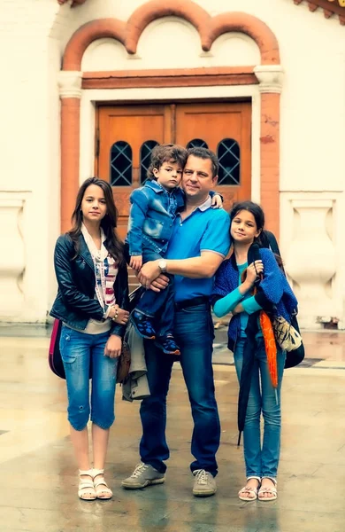 Family walking in the downtown. Historical museum as background