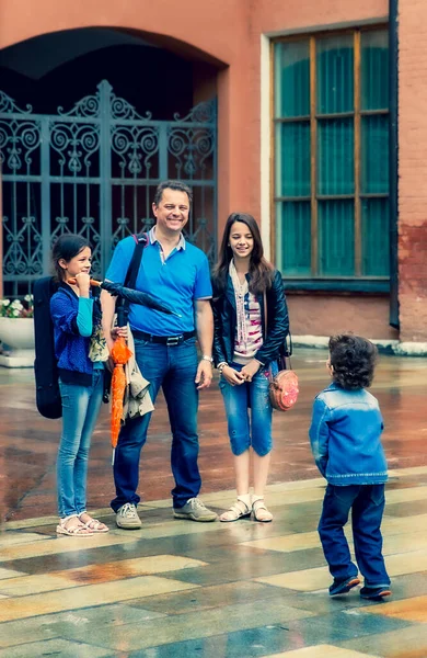Family walking in the downtown. Historical museum as background