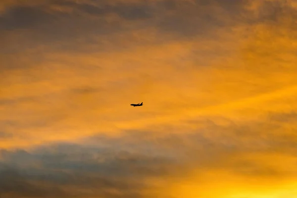 在日落天空飞行的商用飞机 — 图库照片