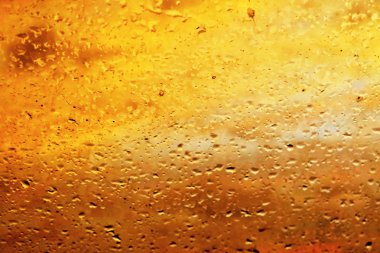 Gün batımında penceresi üzerinde yağmur damlaları