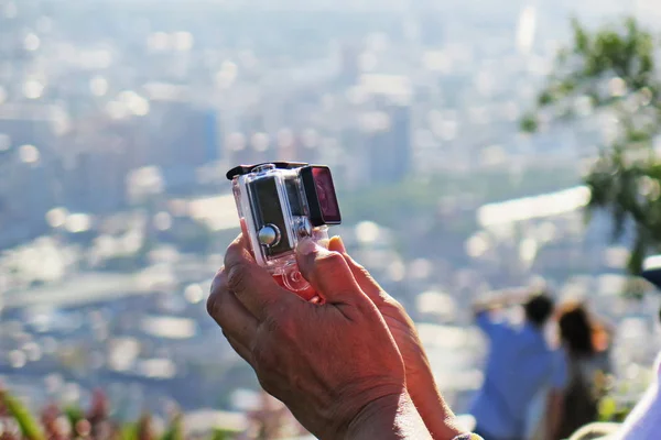 A person taking a selfie photo with action cam