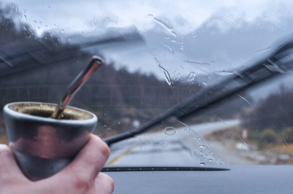 Rain drops on window and Yerba Mate with snowcaped andes mountains background in Neuquen, Patagonia, Argentina