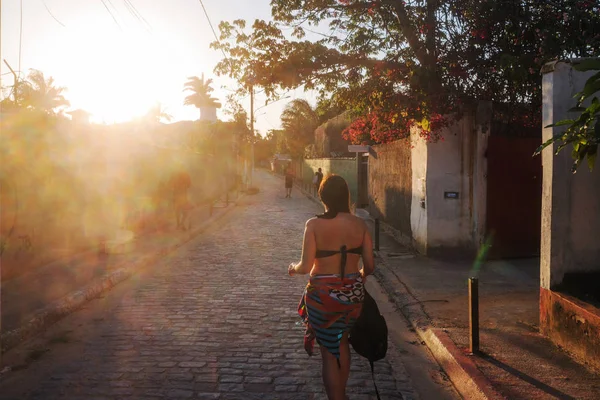 Woman walking at Sunset in Buzios, Brazil