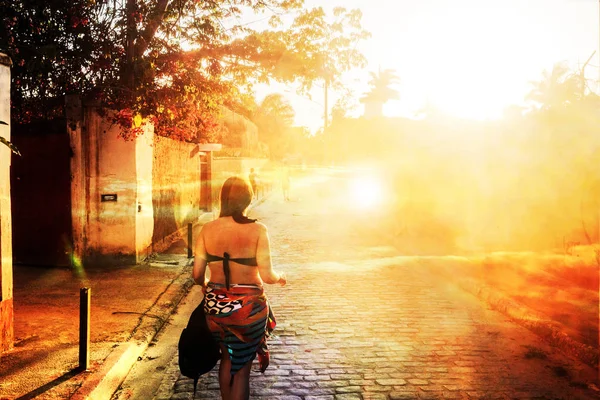 Woman walking at Sunset in Buzios, Brazil