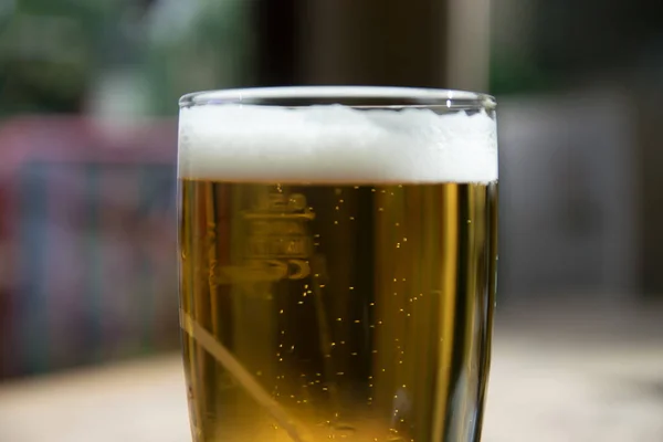 Glass of light beer on a pub