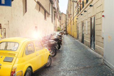 Rome, Italy - May 22, 2017: Old yellow car Fiat 600 parked in a street of Rome, Italy clipart