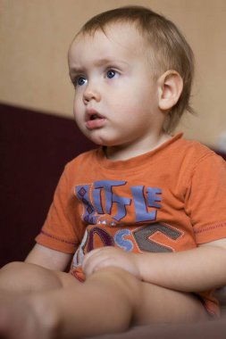 Küçük bir çocuk sitiing evde Tv izlerken