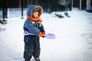 Kışın karda oynarken küçük bir çocuk
