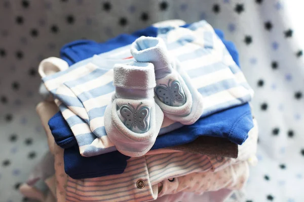 Baby\'s clothes sorted out for a newborn boy in blue and white colors