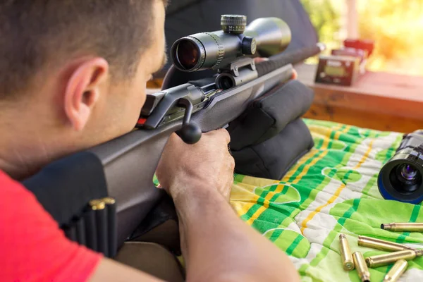 Man holding a rifle at the shooting range