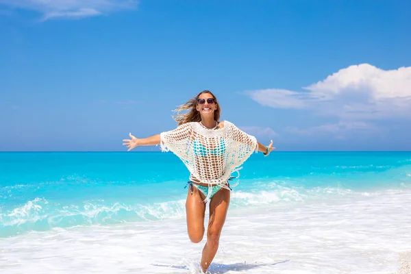 Όμορφη Νεαρή Γυναίκα Που Τρέχει Στην Παραλία Ενώ Χαμογελώντας — Φωτογραφία Αρχείου