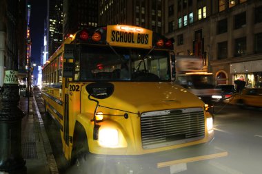 School bus parked on the side of a street in New York City Manha clipart