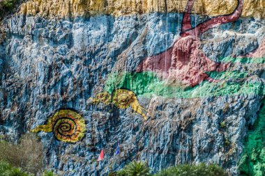 Mural de la Prehistoria (The Mural of Prehistory) painted on a cliff face in the Vinales valley, Cuba. clipart