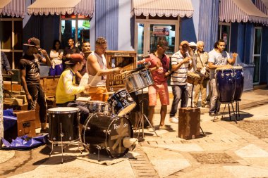 BAYAMO, CUBA - JAN  30, 2016: Local music band performs on a pedestrian street in Bayamo. clipart